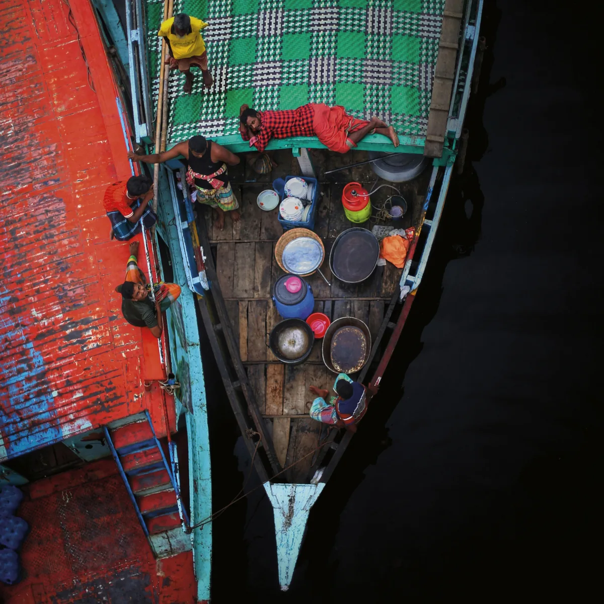 Two wooden boats side by side on dark water, seen from above, converted with a standard ICC conversion to GRACoL 2013 (before)